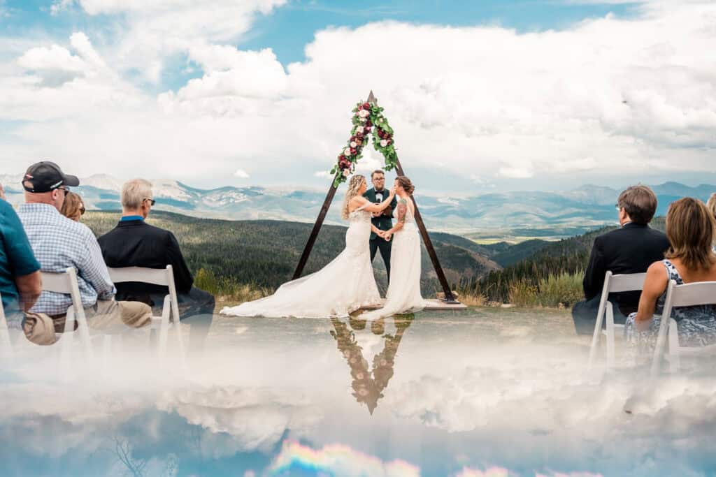 gay couple gets married granby ranch010 A wedding ceremony in the mountains with clouds in the background.