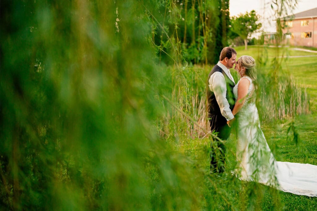 bride-groom-portraits-weeping-willow-maple-grove-events-wi.jpg Bride and groom share a romantic moment outdoors at Maple Grove Events during their wedding.
