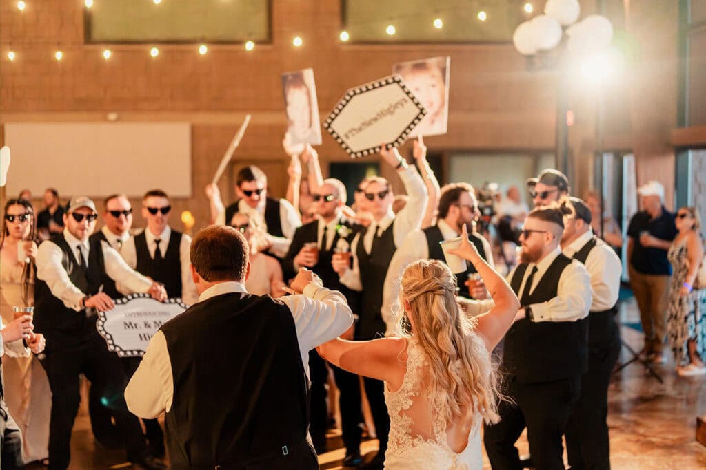 wedding-reception-party-dance-floor-maple-grove-events-west-salem.jpg Wedding reception dance with bride and groom dancing with guests in a lively indoor celebration.