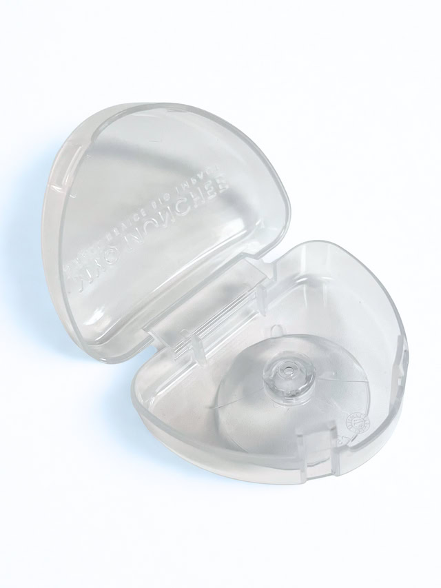 Clear plastic inhaler spacer for respiratory therapy and breathing exercises.