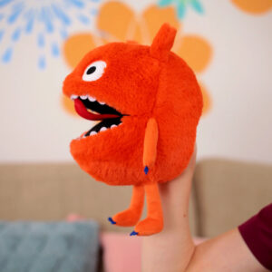 Child holding a colourful plush monster toy, promoting gentle MyoTape for sensitive skin children.