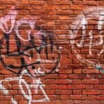 brick wall with paint and graffiti
