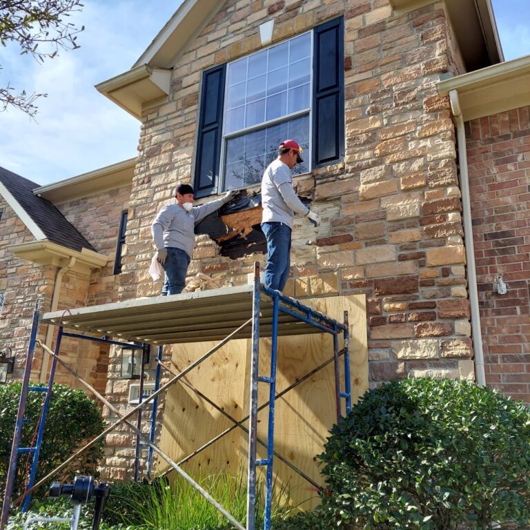 Masons Repairing Loose Stones on Home Masons Repairing Loose Stones on Home