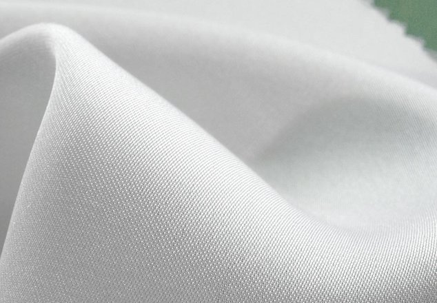 Soft white fabric close-up, high-quality textile material for stylish apparel from Bryden Apparel.