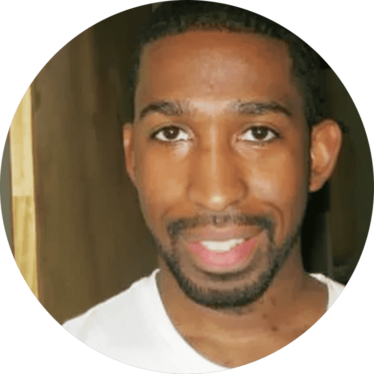 Stylish man wearing casual white t-shirt, smiling, showcasing trendy men's fashion from Bryden Apparel.