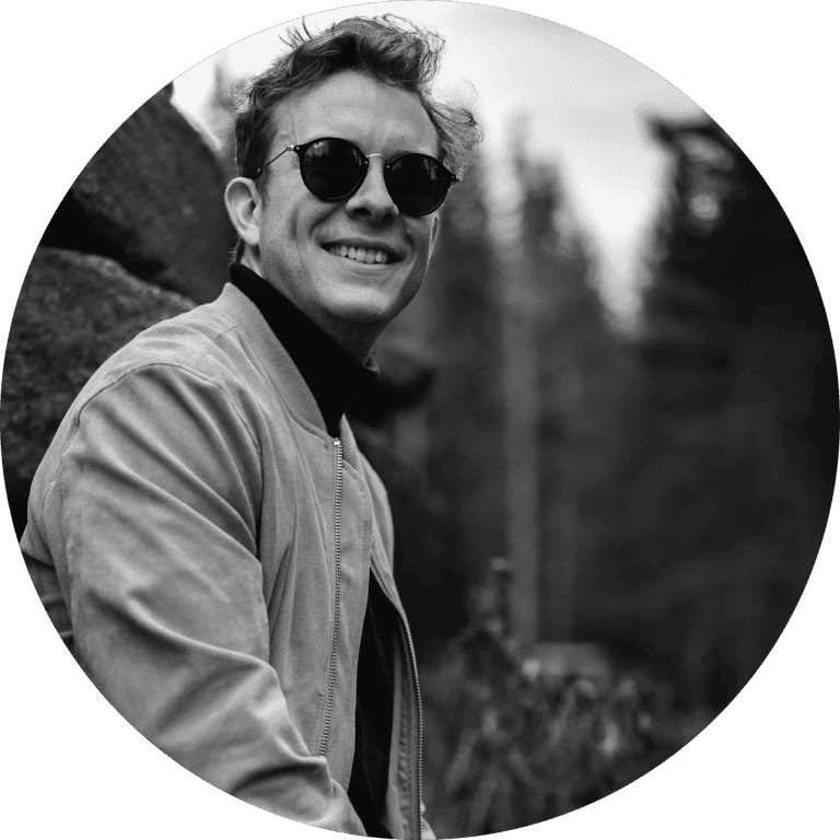 Stylish man wearing sunglasses and casual jacket, outdoor fashion portrait, modern men's apparel.