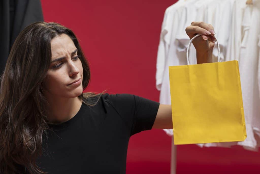 beautiful-woman-looking-yellow-shopping-bag