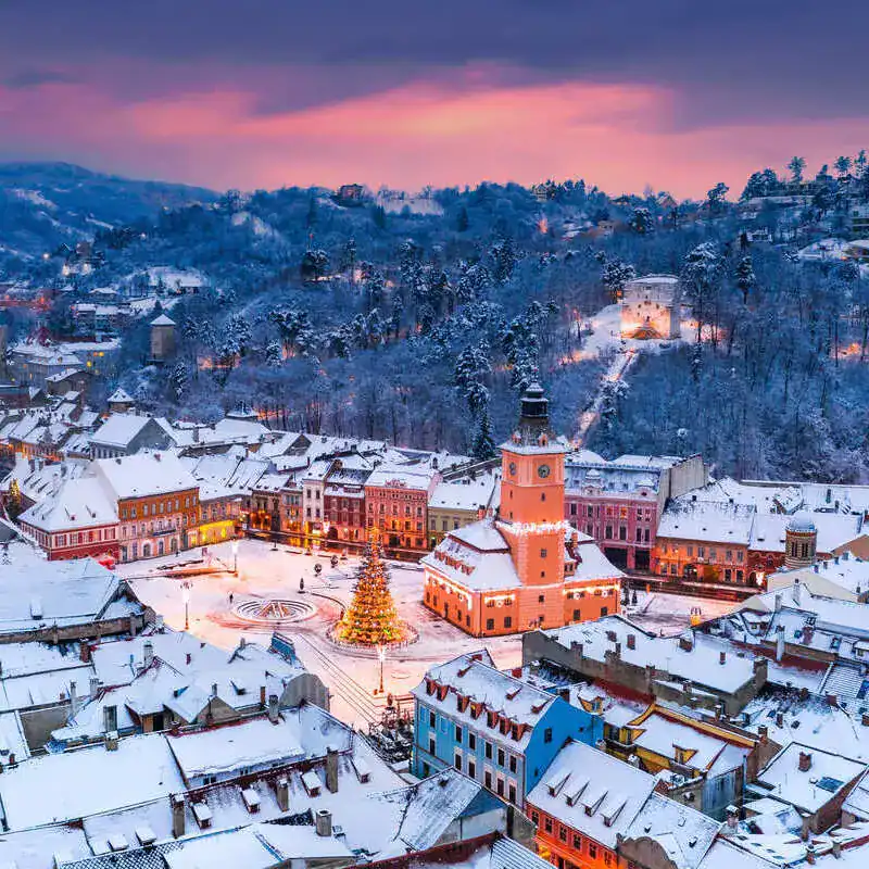 Brașov Private Tour - Snowy Town Square with Christmas Decorations.