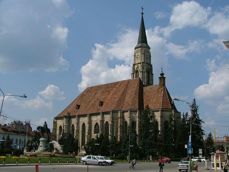 Iconic Cluj church with tall steeple, part of a private tour from Bucharest.