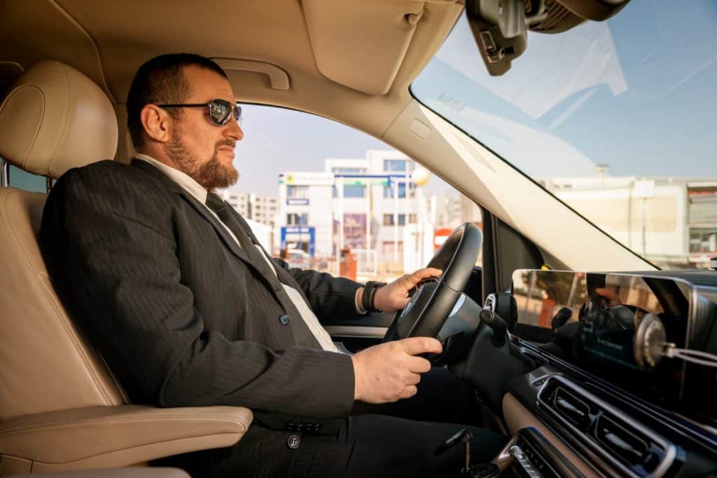 Professional chauffeur driving a Mercedes V-Class for Bud’s Cab