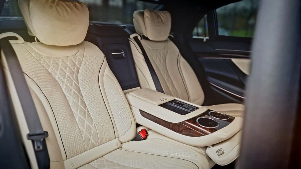 Premium rear cabin interior with leather seats and ambient lighting in a luxury chauffeur vehicle