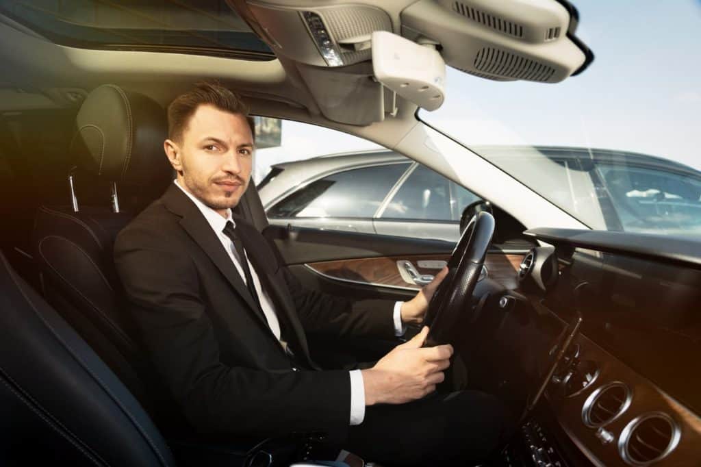 Young professional chauffeur driving an executive car for Bud’s Cab