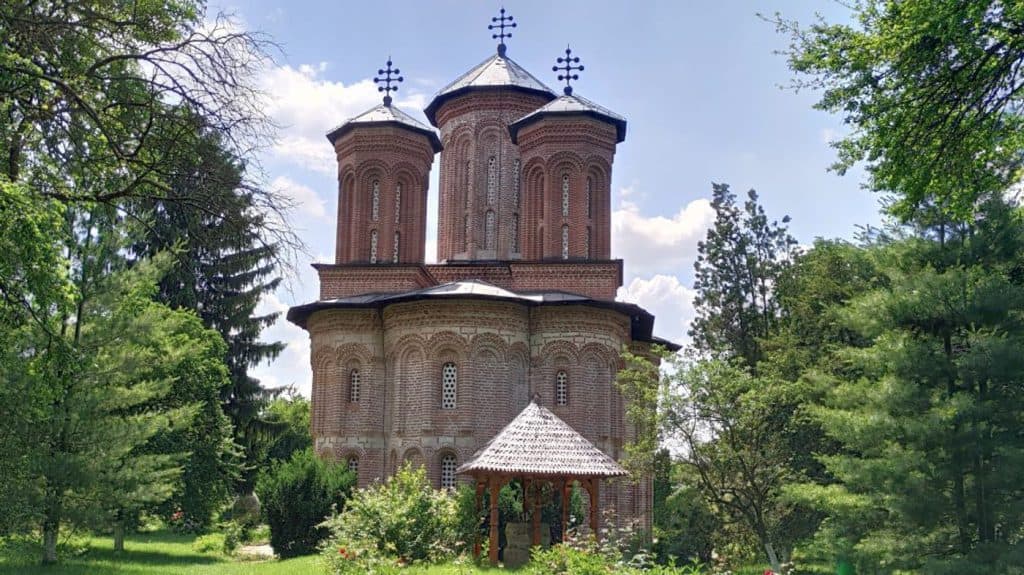 Historic church at Snagov Monastery near Bucharest surrounded by trees
