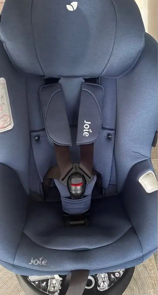 Blue Joie baby car seat with harness straps.
