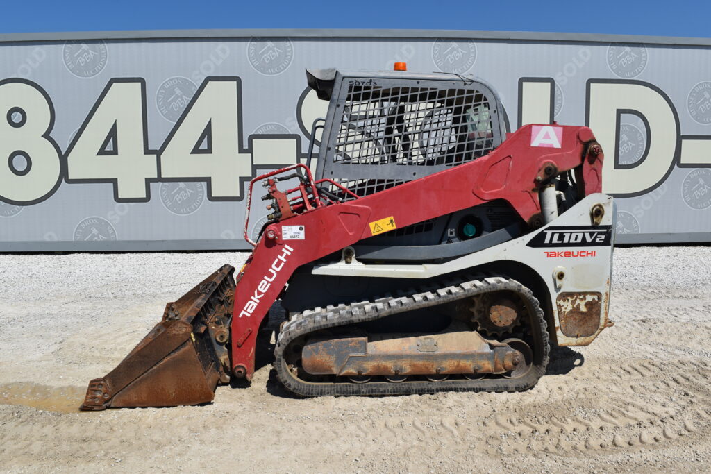 Red Takeuchi compact track loader at heavy equipment auction.