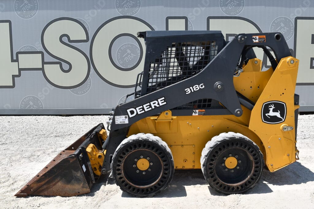 John Deere 318G compact loader at heavy equipment auction.