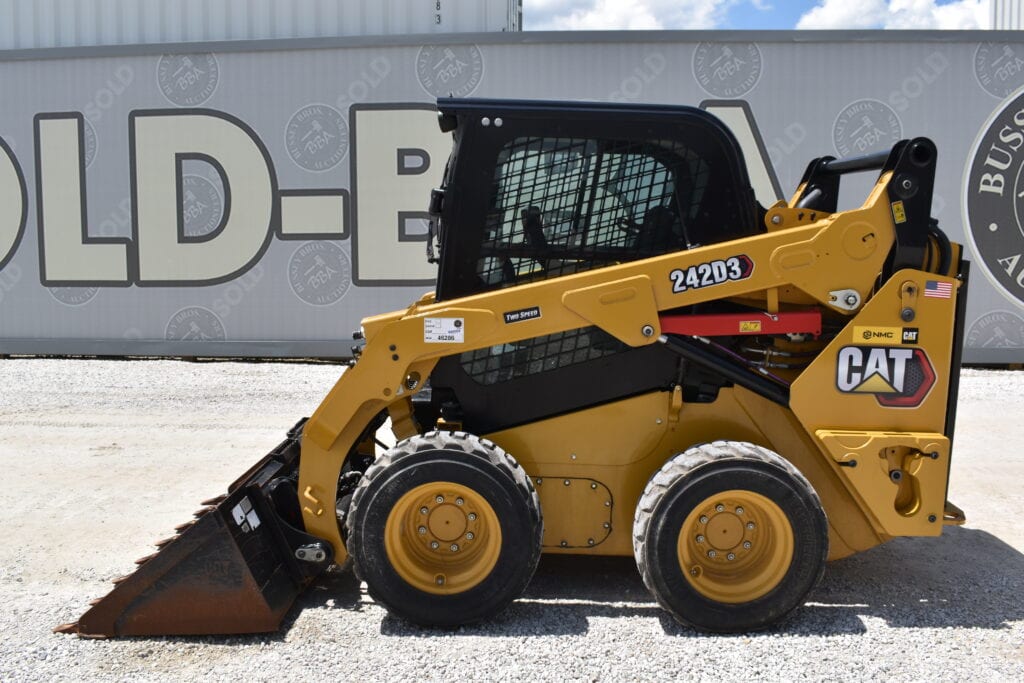 Yellow CAT 242D3 compact loader at heavy equipment auction.