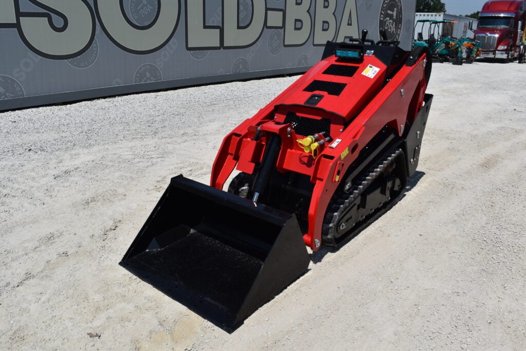 Red mini skid steer loader at Bussey Bros Auctioneers.