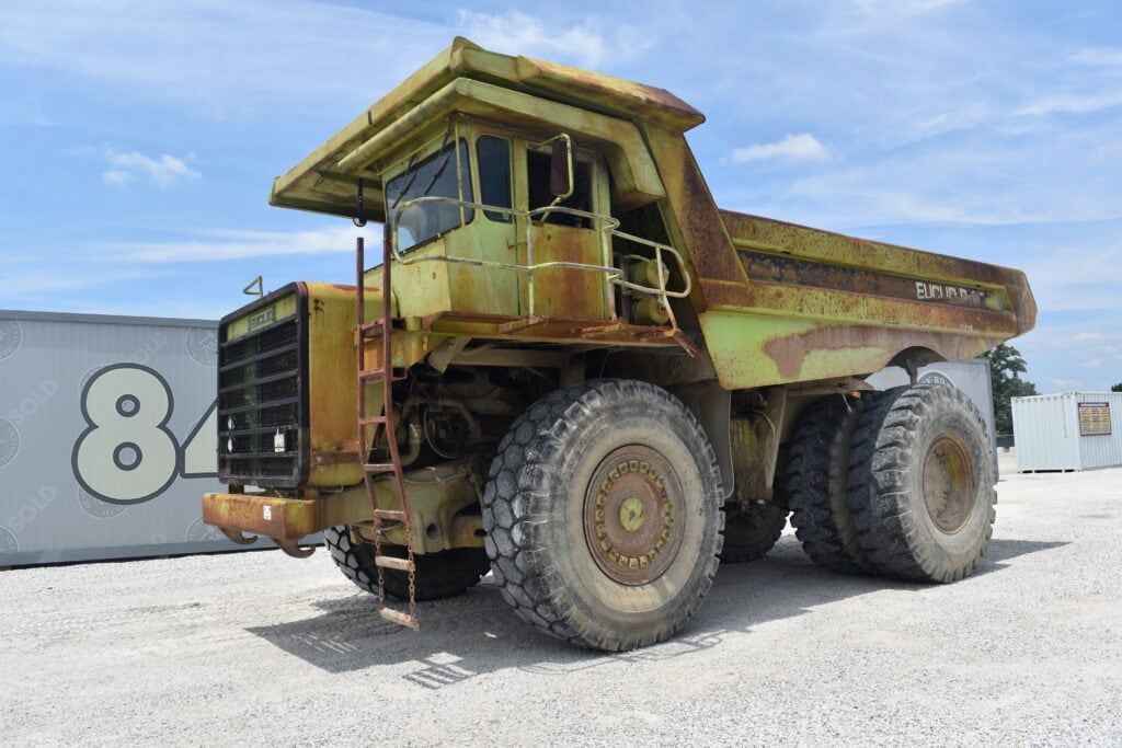 Large vintage dump truck at heavy equipment auction site.