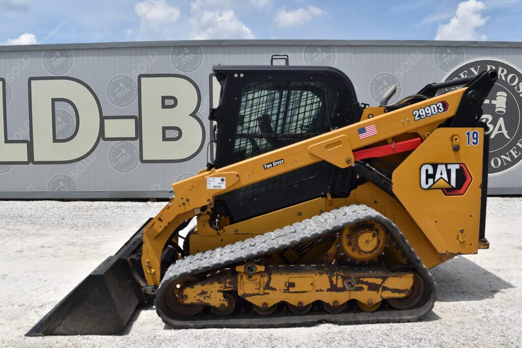 Yellow CAT compact track loader at heavy equipment auction.