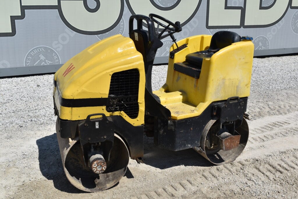 Yellow road roller at Bussey Bros Auctioneers heavy equipment sale.