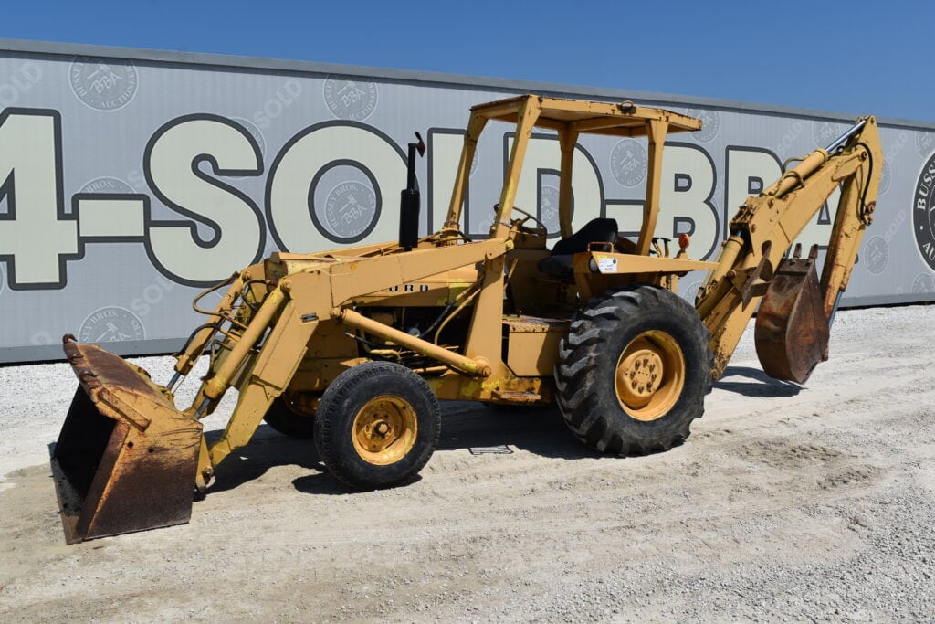 Yellow backhoe loader at heavy equipment auction site.