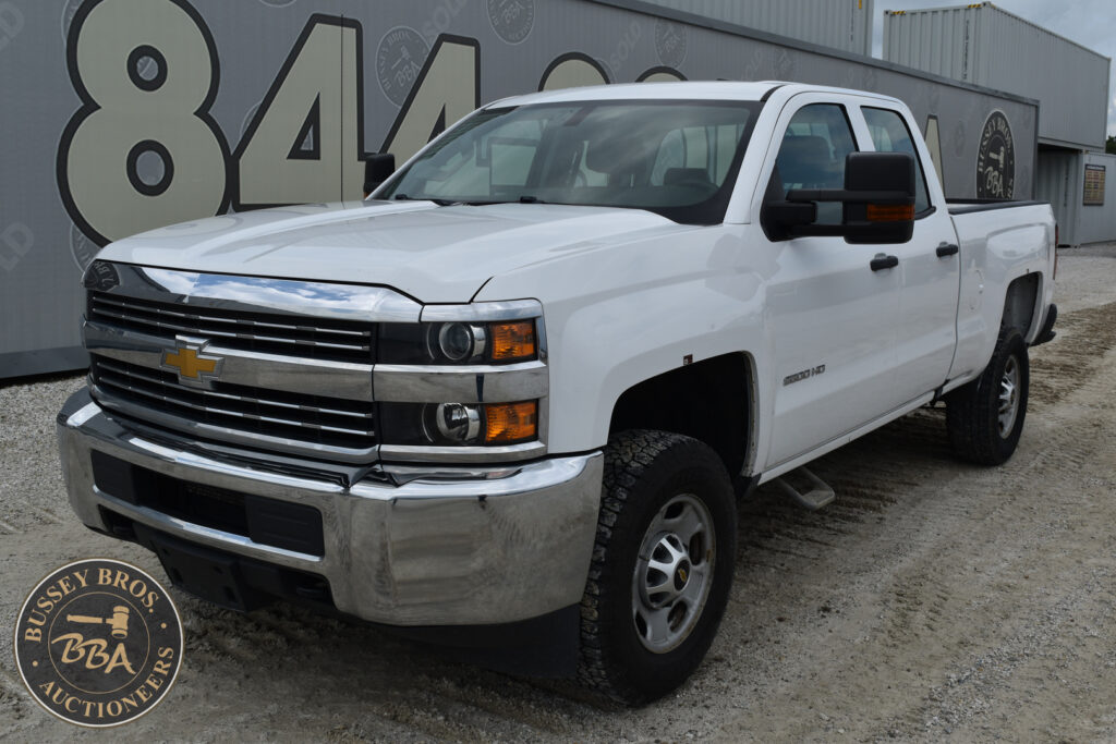 White Chevrolet Silverado pickup truck at heavy equipment auction lot.