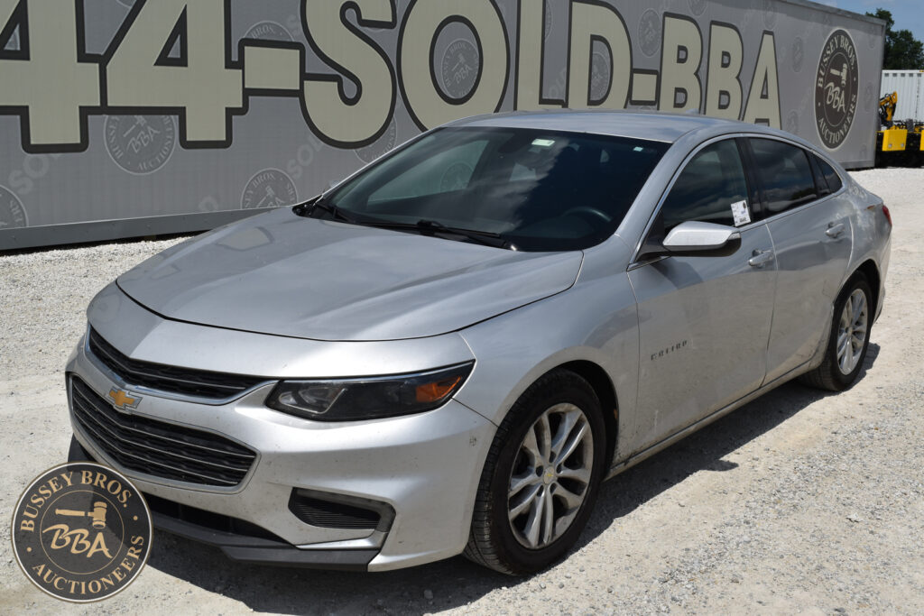 Silver Chevrolet Malibu sedan at Bussey Bros Auction lot.