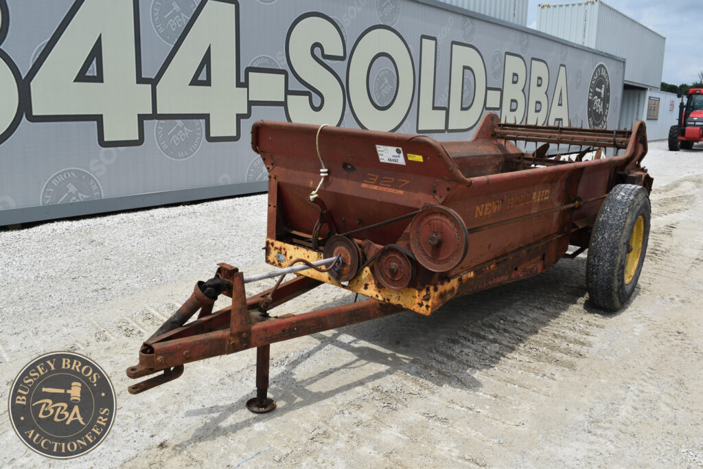 Rusty agricultural conveyor with large tires for sale at auction.