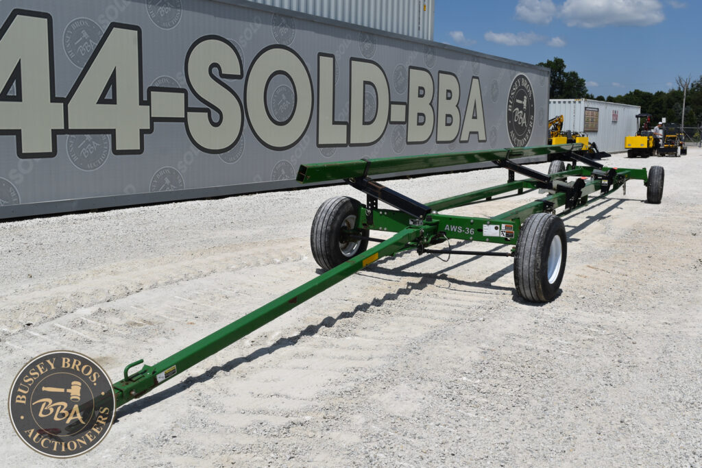 Green agricultural equipment trailer at Bussey Bros auction site.