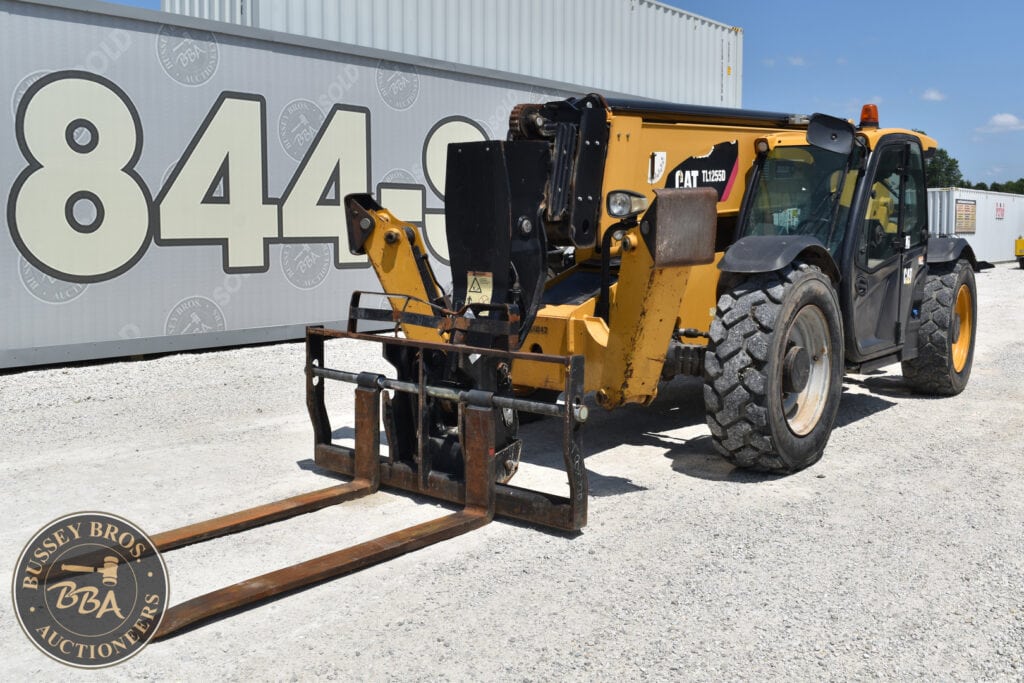 Yellow Caterpillar telehandler with forks at heavy equipment auction.
