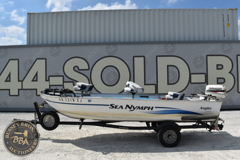 Sea Nymph Angler boat on trailer at auction lot.