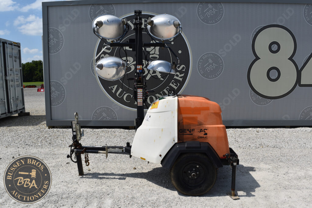 Mobile lighting tower with four large floodlights for construction sites.