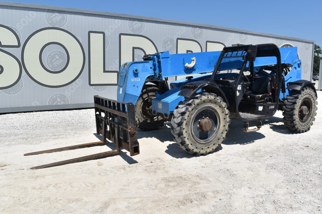 Blue telehandler forklift at heavy equipment auction site.