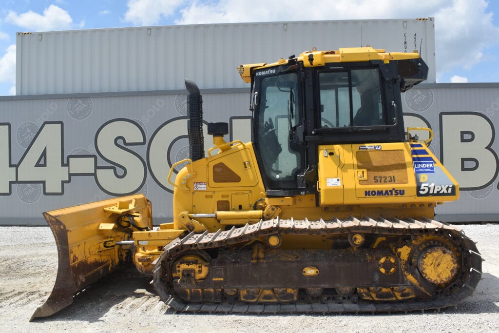 Yellow Komatsu bulldozer at a heavy equipment auction site.