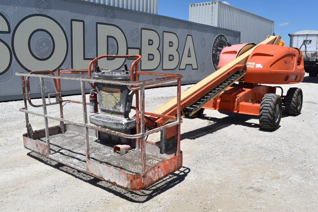 Orange boom lift with basket at Bussey Bros Auctioneers.