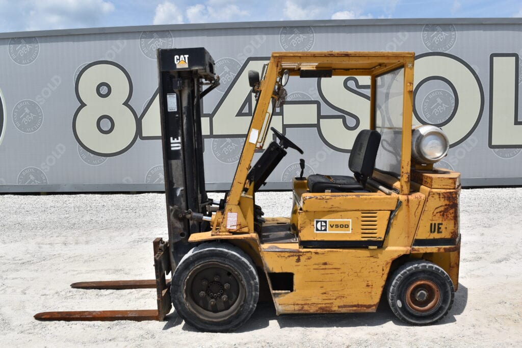 Yellow forklift with black mast at heavy equipment auction.