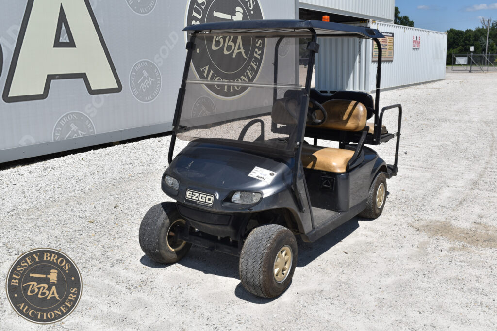 Black electric golf cart with tan seats at Bussey Bros Auction.