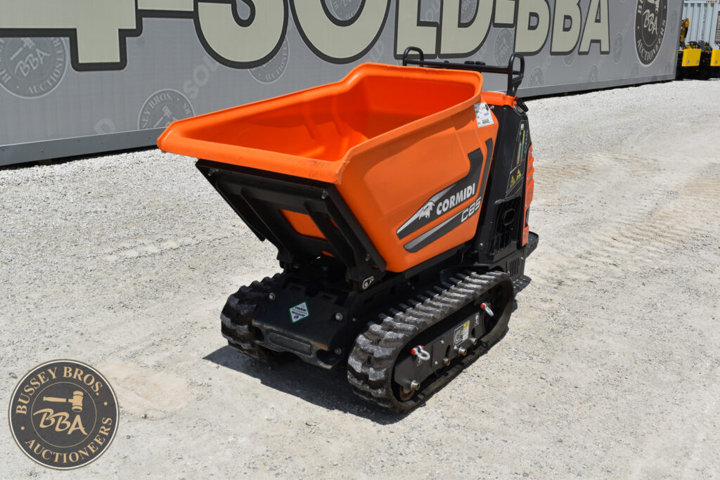 Compact mini track dumper with orange hopper and rubber tracks.