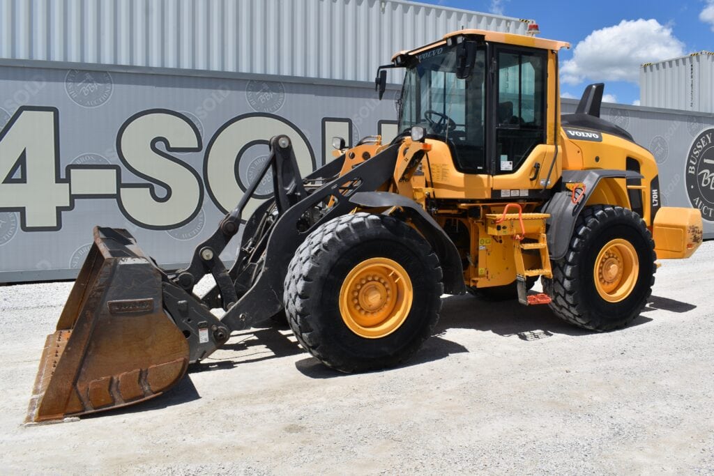 Yellow Volvo wheel loader at heavy equipment auction site.