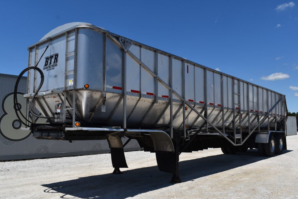 Large silver heavy equipment trailer at Bussey Bros Auctioneers.
