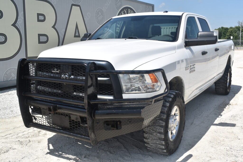 White heavy-duty pickup truck with black grille guard at auction.