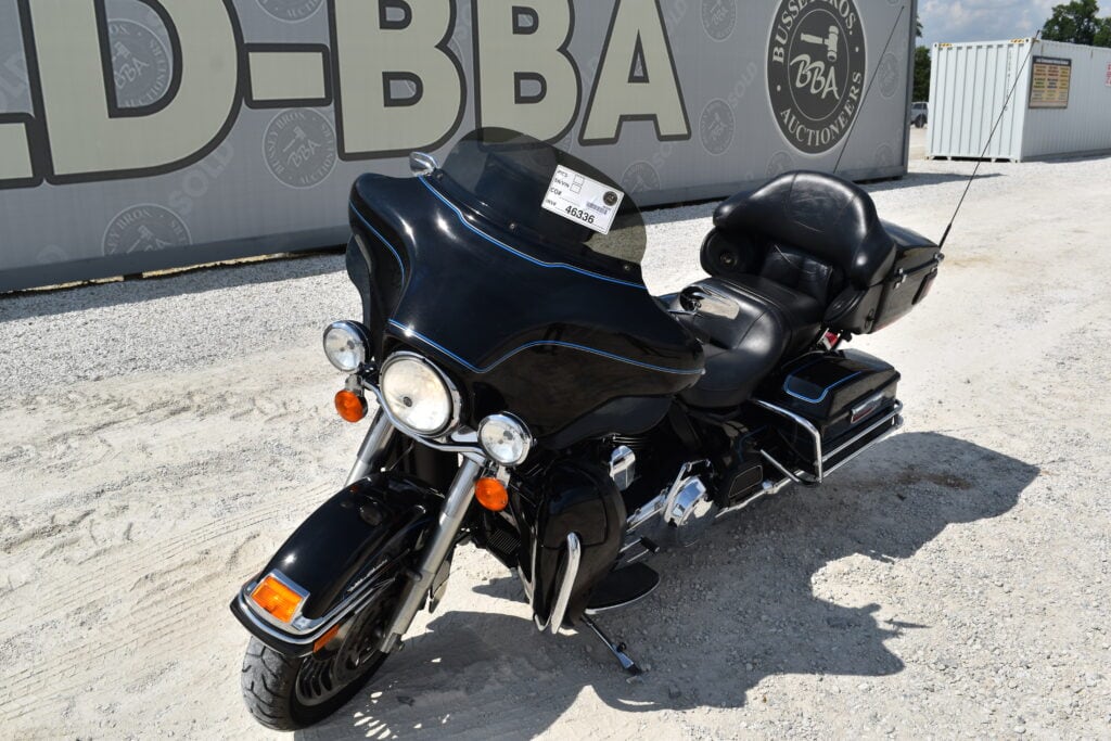Black touring motorcycle with large windshield and storage compartments.