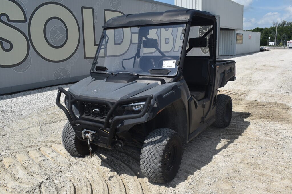 Black utility vehicle with cargo bed at heavy equipment auction.