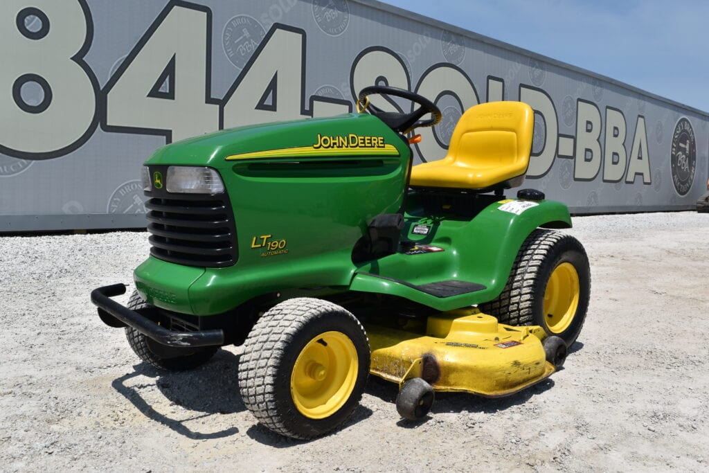 Green and yellow John Deere LT190 lawn tractor with mower deck.