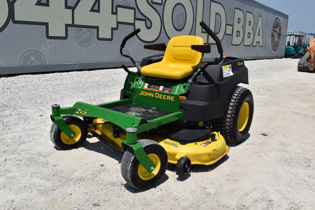 John Deere zero turn mower with yellow seat and green body at auction.