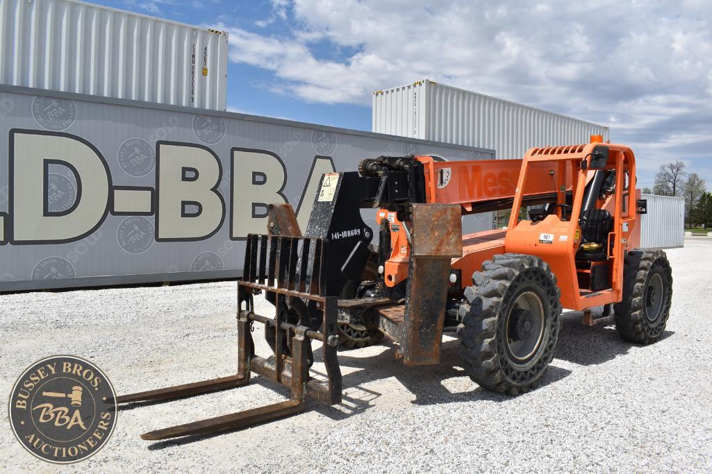 Forklift with orange arms and black forks in front of shipping containers.