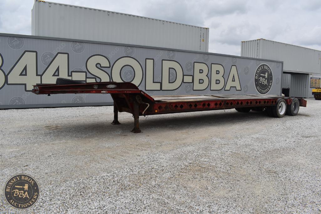 Heavy-duty flatbed trailer for sale at Bussey Bros Auctioneers, ideal for transporting large machine.