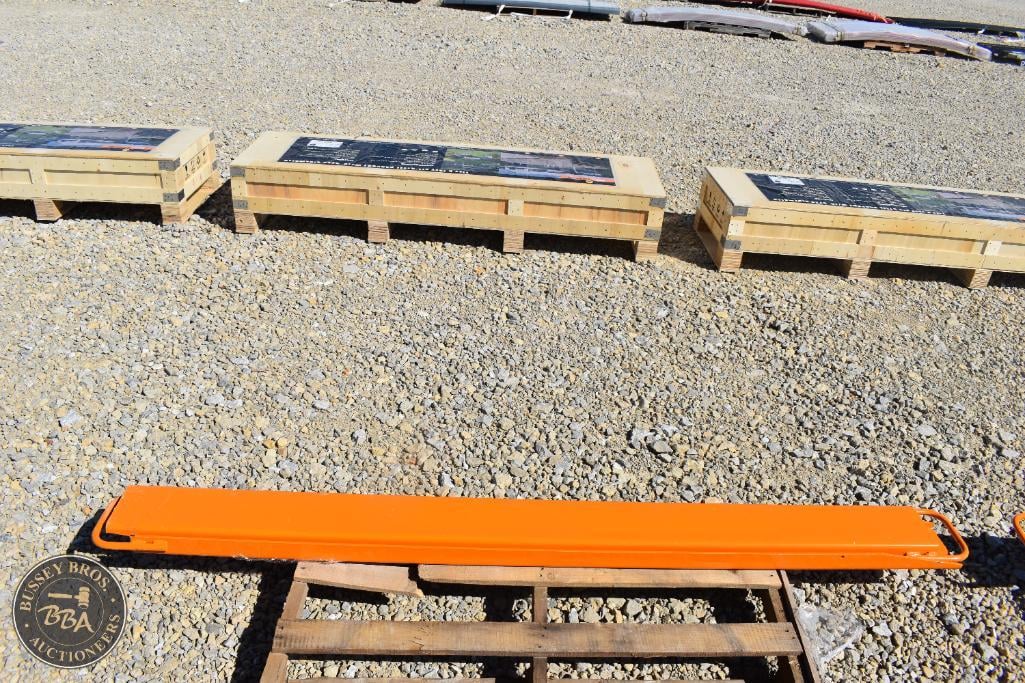 Outdoor equipment including a bright orange safety barrier on a wooden pallet at a Bussey Bros aucti.