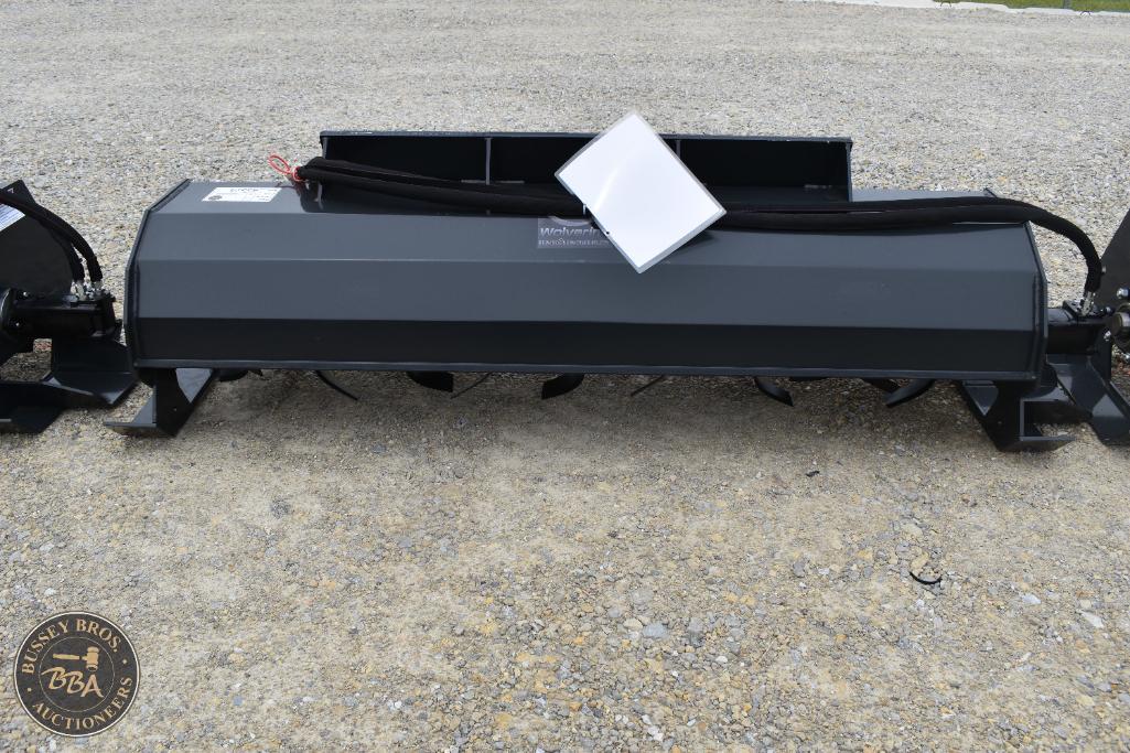Heavy-duty farm implement attachment displayed on gravel surface.
